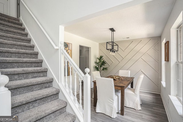 dining area with hardwood / wood-style floors and a healthy amount of sunlight