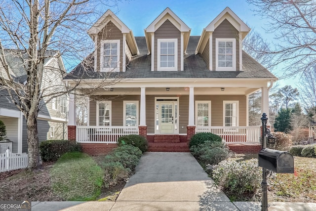 cape cod house featuring a porch