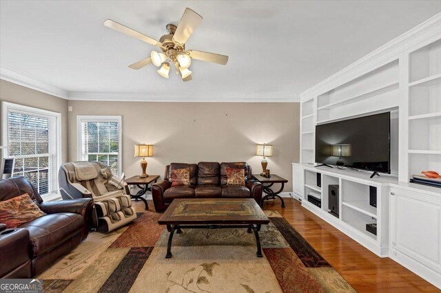 living room featuring crown molding, ceiling fan, and hardwood / wood-style flooring