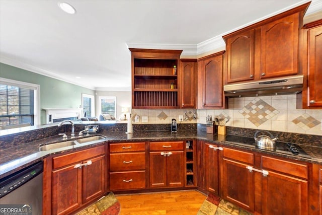 kitchen featuring sink, ornamental molding, stainless steel dishwasher, dark stone counters, and light wood-type flooring