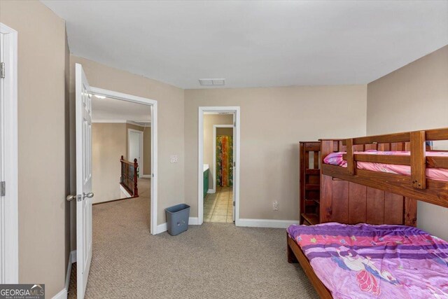 bedroom featuring light colored carpet