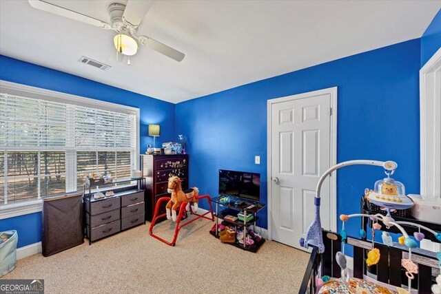 game room with light carpet and ceiling fan