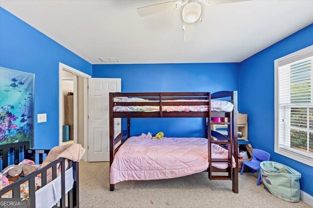 bedroom featuring light colored carpet and ceiling fan