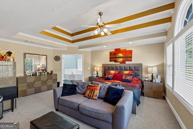 bedroom featuring multiple windows, ornamental molding, a raised ceiling, and ceiling fan