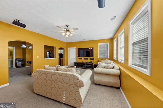 living room featuring light carpet and ceiling fan