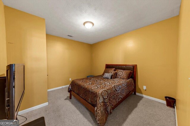 carpeted bedroom with a textured ceiling