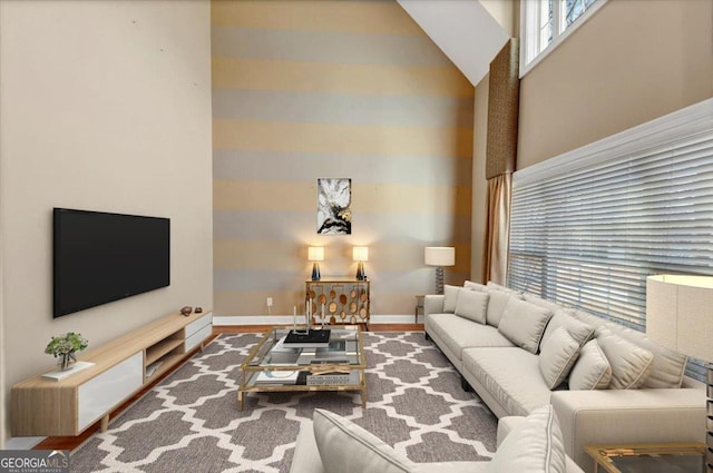 living room featuring hardwood / wood-style flooring and high vaulted ceiling