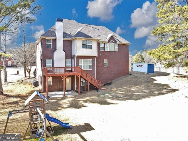 rear view of property with a playground