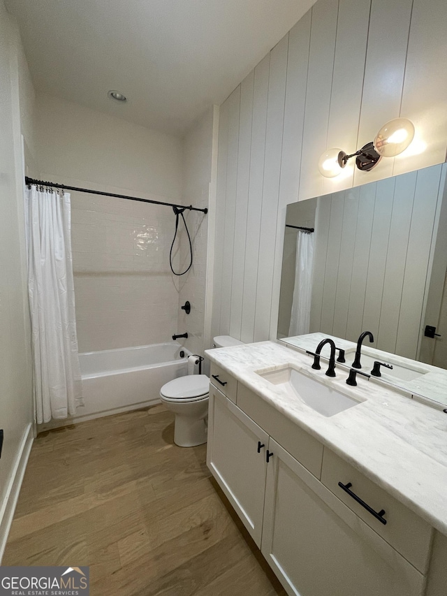 full bathroom featuring toilet, shower / bath combo with shower curtain, vanity, and hardwood / wood-style flooring