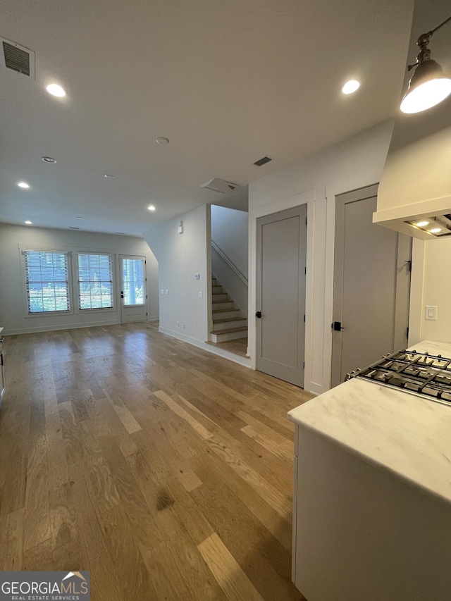 unfurnished living room with light hardwood / wood-style flooring