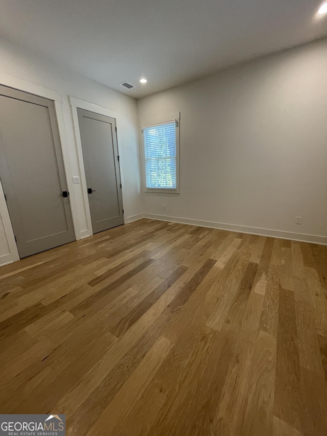 unfurnished room featuring light wood-type flooring