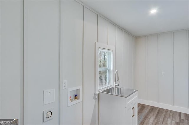 laundry room featuring light wood-type flooring, sink, and hookup for a washing machine