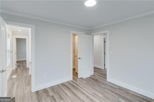 unfurnished bedroom with light hardwood / wood-style floors and ornamental molding