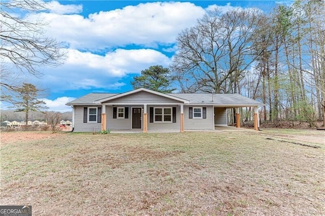 ranch-style house with a carport, a porch, and a front lawn