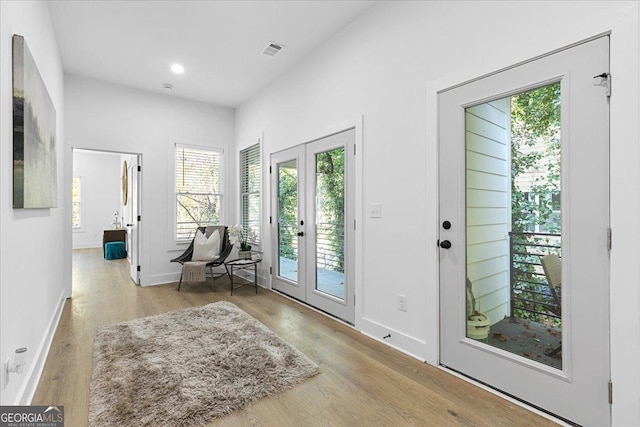 doorway to outside featuring light hardwood / wood-style flooring and french doors