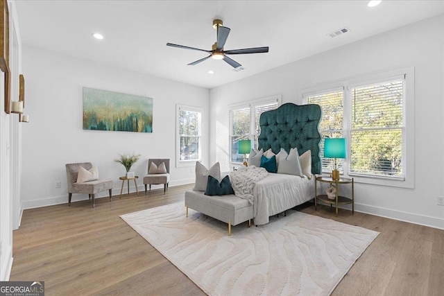 bedroom with ceiling fan and light wood-type flooring