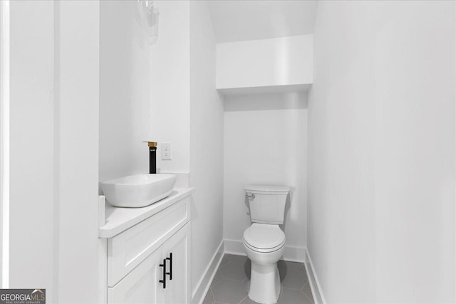 bathroom with tile patterned floors, vanity, and toilet