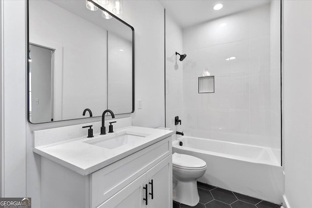 full bathroom with tile patterned floors, vanity, toilet, and washtub / shower combination