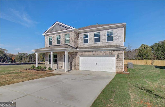 view of front of house featuring a porch, a garage, and a front yard