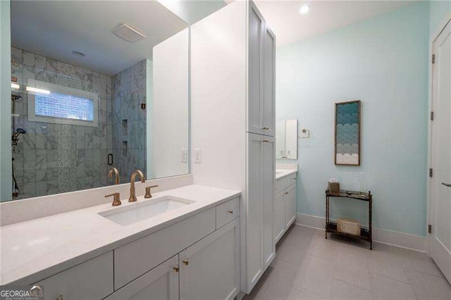 bathroom featuring tile patterned flooring, vanity, and a shower with shower door