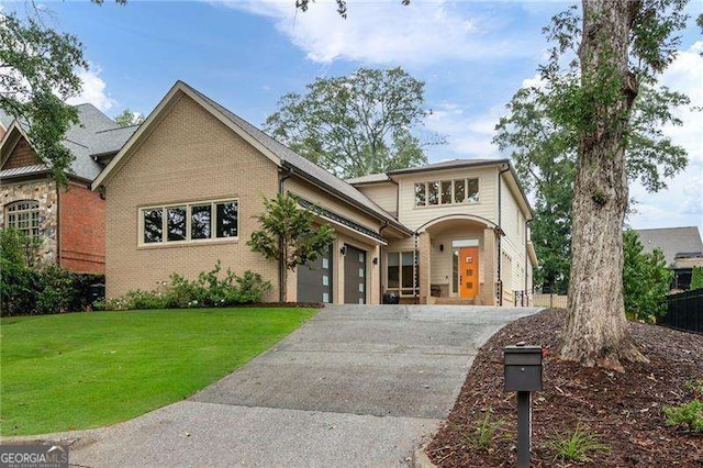 view of front of house featuring a garage and a front lawn