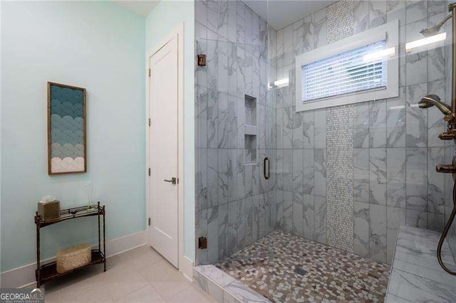 bathroom with tile patterned flooring and a shower with door