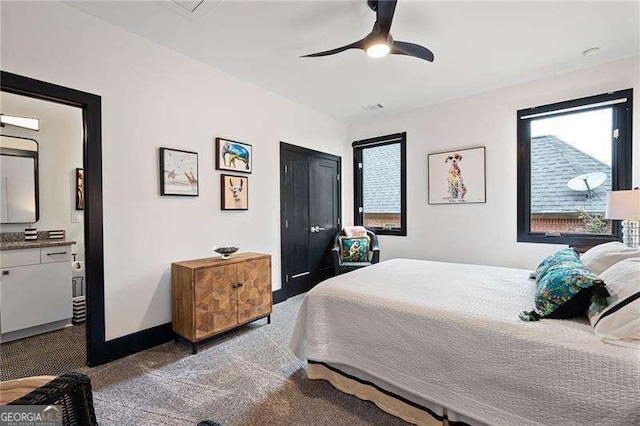 carpeted bedroom featuring ceiling fan and ensuite bathroom