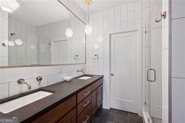 bathroom featuring tile patterned floors, decorative backsplash, a shower with door, and tile walls