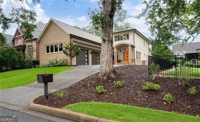 view of front of house featuring a garage and a front lawn