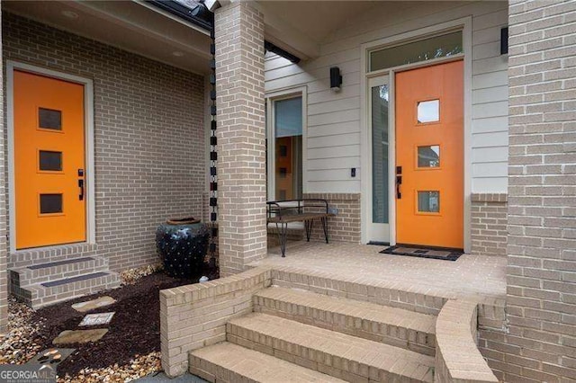 view of exterior entry featuring covered porch