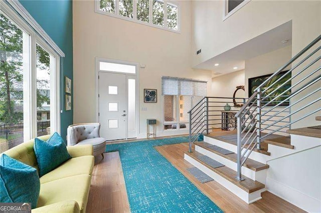 interior space with wood-type flooring and a high ceiling