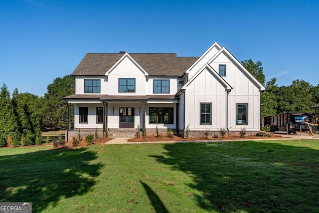 view of front facade with a front lawn and covered porch