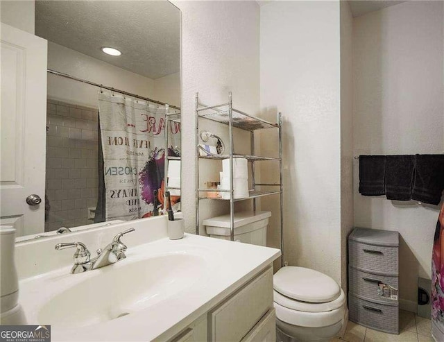 bathroom featuring a shower with shower curtain, tile patterned floors, a textured ceiling, vanity, and toilet