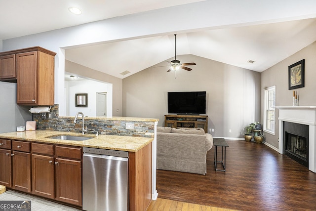 kitchen featuring sink, backsplash, kitchen peninsula, and dishwasher