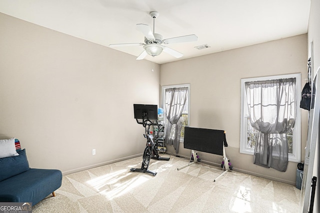 workout room featuring light colored carpet and ceiling fan