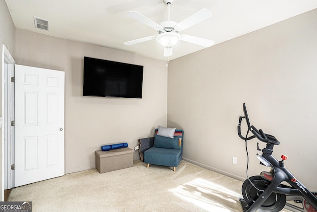 exercise room featuring light colored carpet and ceiling fan