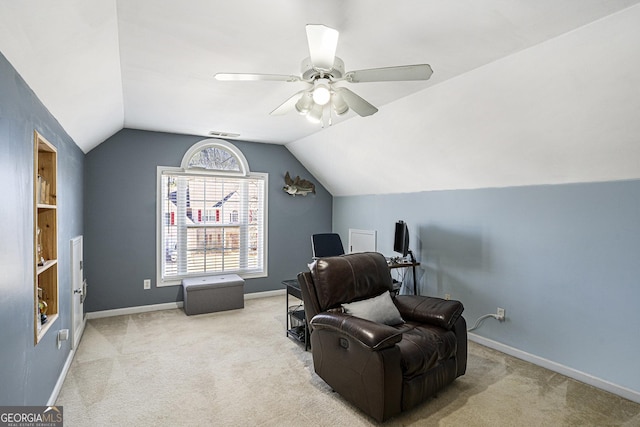 living area with ceiling fan, lofted ceiling, and light colored carpet