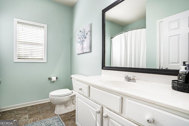 bathroom featuring vanity and toilet