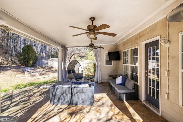 view of patio featuring an outdoor living space with a fire pit and ceiling fan