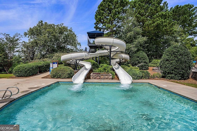 view of swimming pool with a water slide