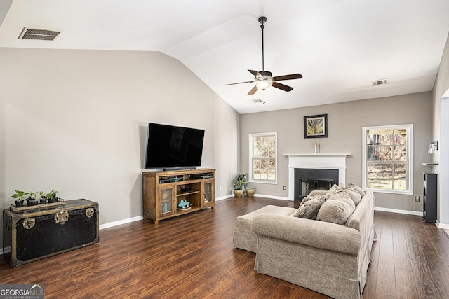 living room with ceiling fan, lofted ceiling, a healthy amount of sunlight, and dark hardwood / wood-style floors