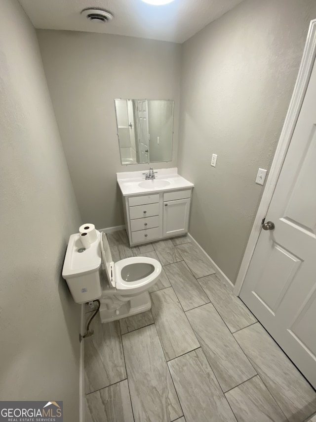 bathroom with vanity and toilet