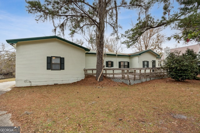 back of house featuring a deck