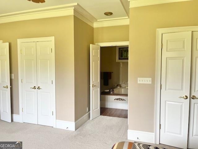 bedroom with light colored carpet and ornamental molding