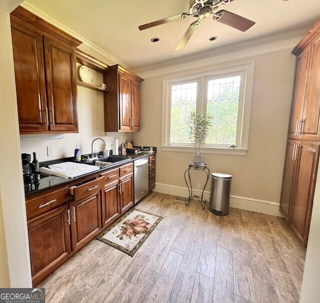 kitchen featuring stainless steel dishwasher, light hardwood / wood-style floors, ornamental molding, and sink