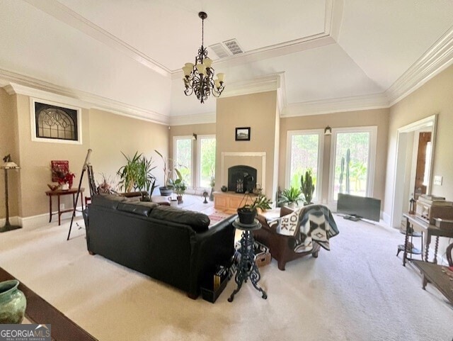 carpeted living room featuring crown molding, a healthy amount of sunlight, lofted ceiling, and an inviting chandelier