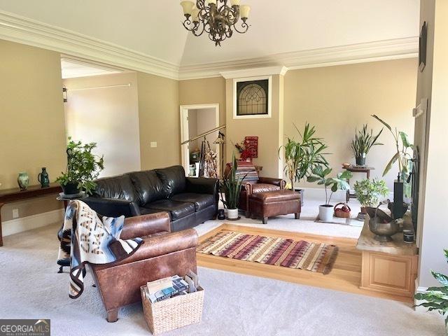 living room with carpet floors, lofted ceiling, crown molding, and an inviting chandelier