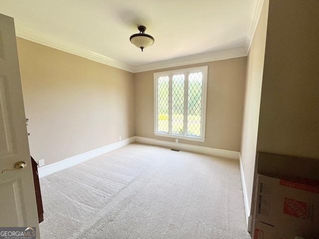 carpeted spare room with ornamental molding