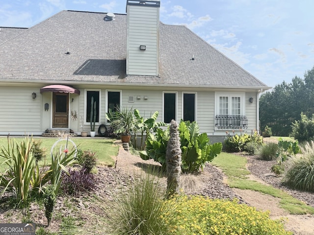 rear view of house with a lawn