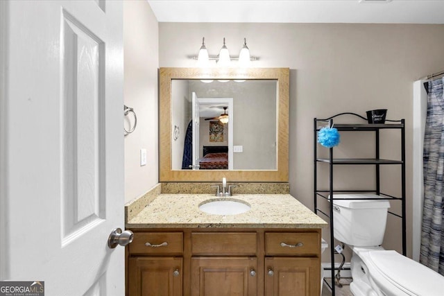 bathroom featuring ceiling fan, vanity, and toilet